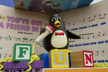 Wheezy, from Toy Story, singing "You've Got a Friend in Me" with blocks spelling "FUN"
