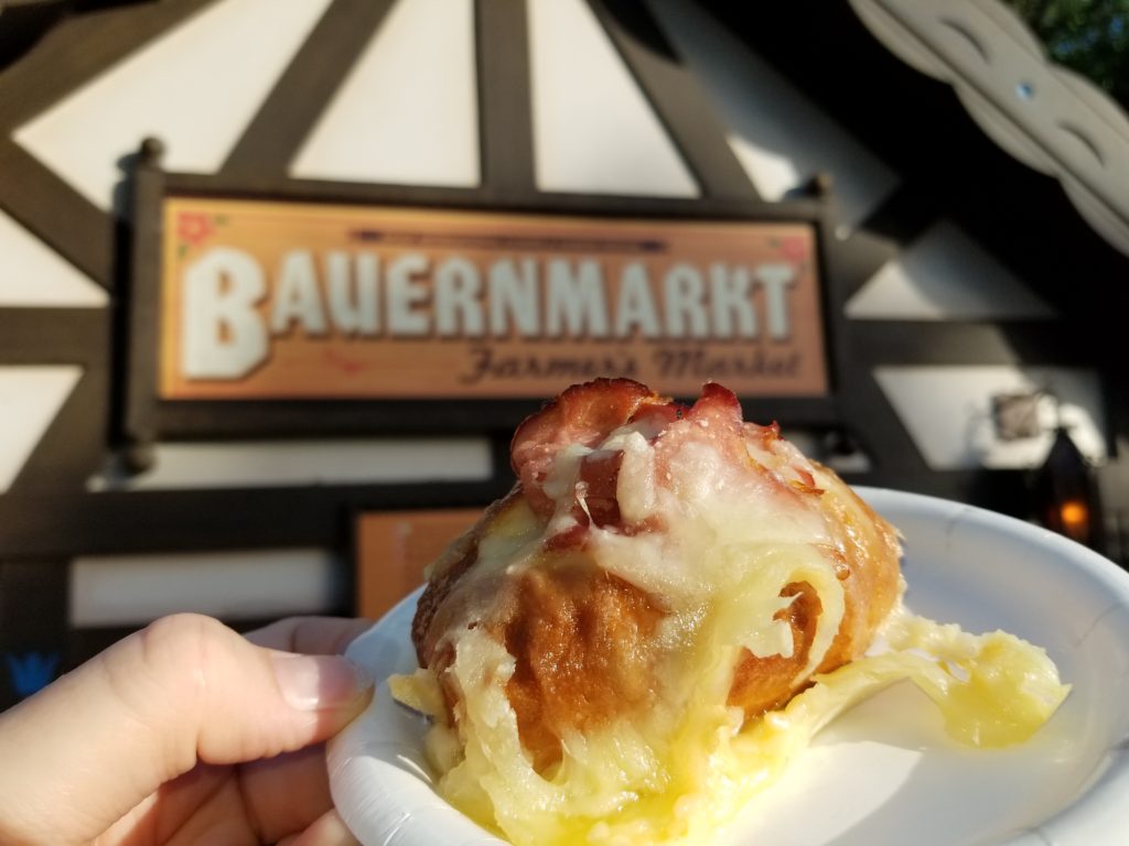 Toasted Pretzel Bread topped with Black Forest Ham and Melted Gruyère Cheese in front of the Bauernmarkt: Farmer’s Market booth in the German Pavilion