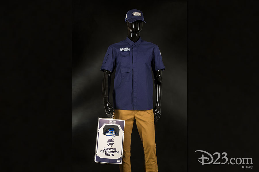 Mannequin wearing Droid Depot Clothing and holding a box with a droid in it.