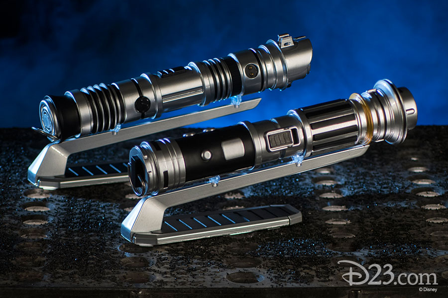 Two lightsaber hilts on stands.