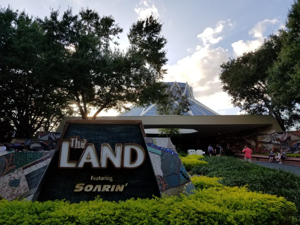 A Picture of the Land Pavilion in Epcot with the sunsetting in the background.