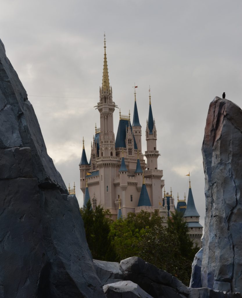A picture of Cinderella Castle between the big boulders in Tomorrowland.  