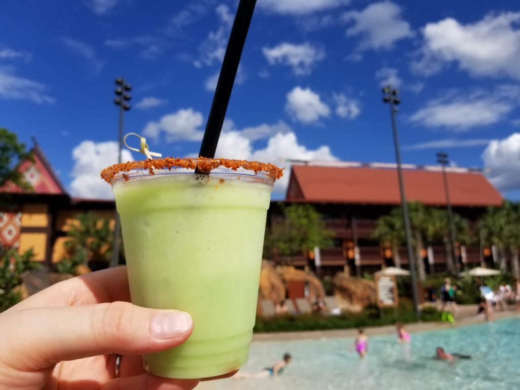 The Frozen Margarita with Dole Whip Lime--an adults only Disney snack in front of the Barefoot Pool Bar at Disney's Polynesian Resort.