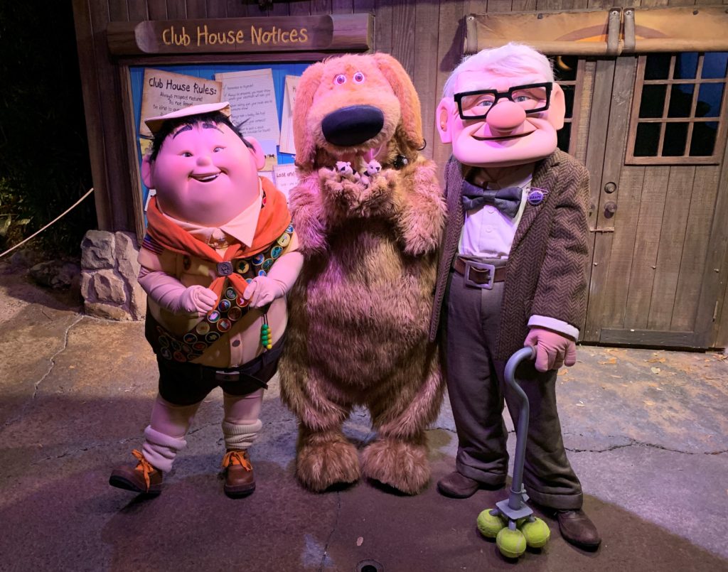 Russell, Dug, and Carl Fredricksen from the Pixar movie, "Up" standing together at Disney's Animal Kingdom's Moonlight Magic event